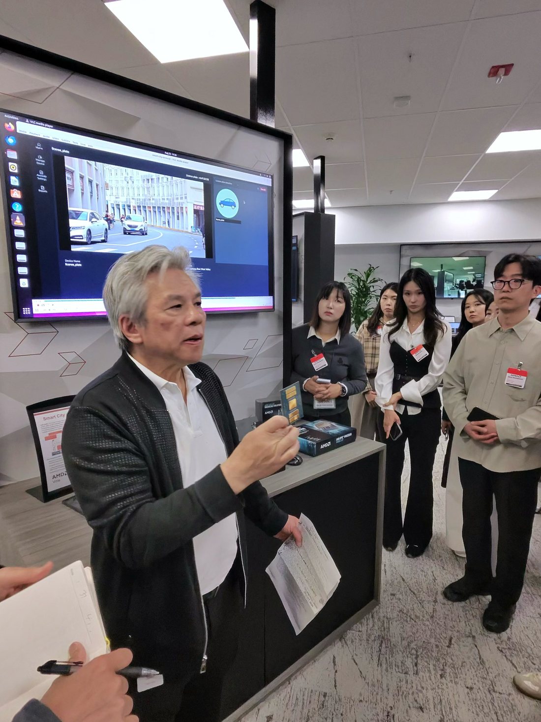 Delegation members watching a product demonstration during the AMD tour